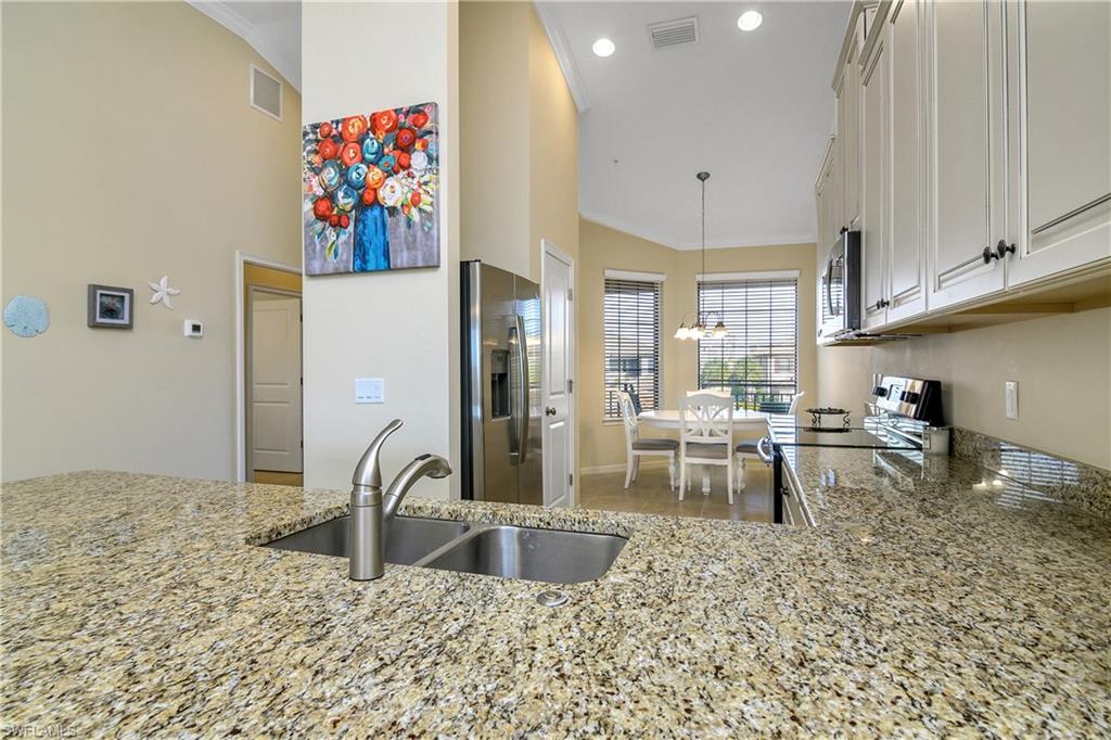 9440 Benvenuto Court, Unit 3204 Naples, FL 34119 - Photo 17 of 28 a view of a kitchen with appliances and cabinets
