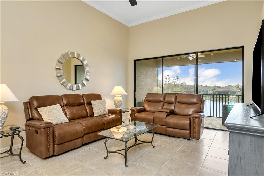 9440 Benvenuto Court, Unit 3204 Naples, FL 34119 - Photo 20 of 28 a living room with furniture and a large window