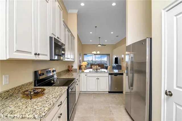 a kitchen with stainless steel appliances granite countertop a refrigerator sink and stove