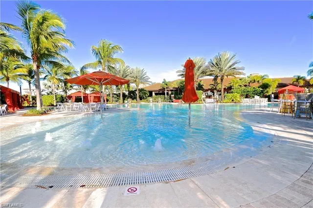 a view of a swimming pool with an outdoor space and seating area