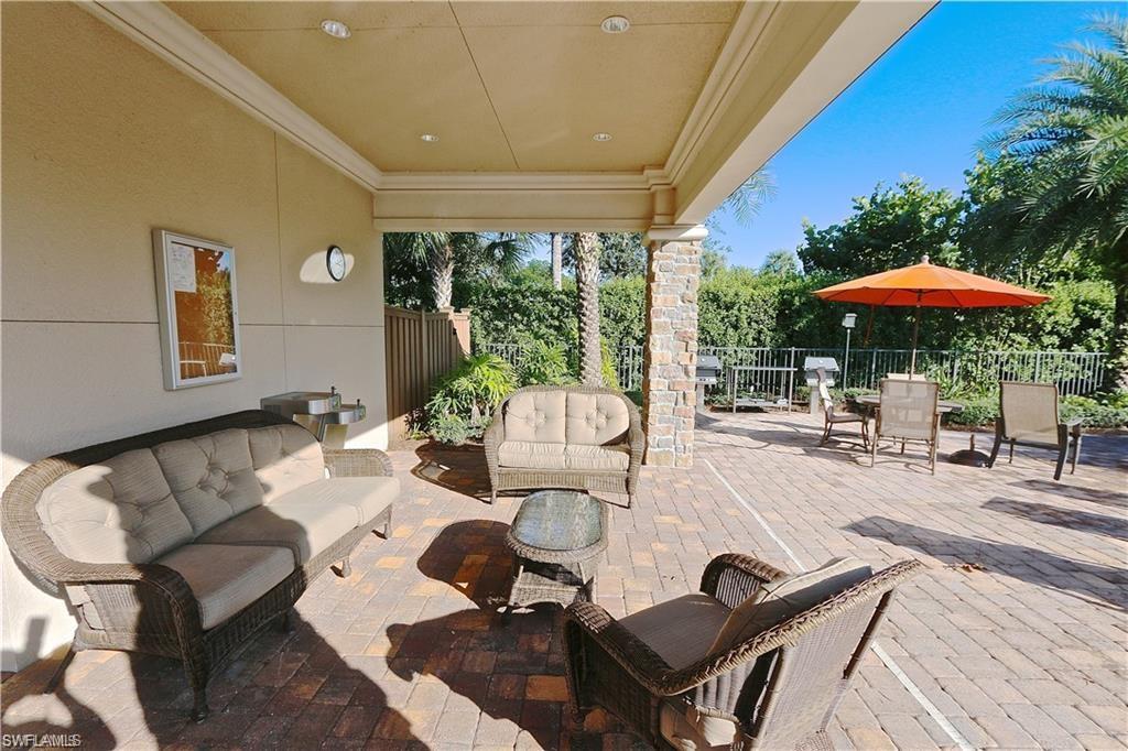 9440 Benvenuto Court, Unit 3204 Naples, FL 34119 - Photo 5 of 28 a view of a patio with furniture and wooden floor
