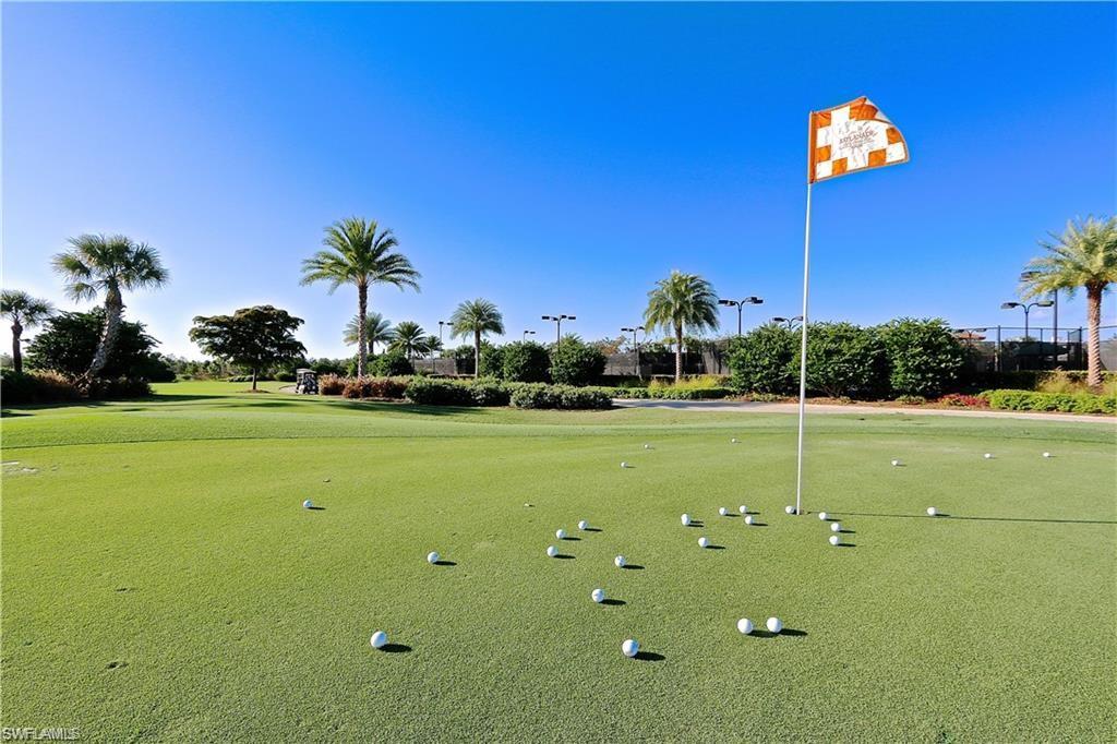 9440 Benvenuto Court, Unit 3204 Naples, FL 34119 - Photo 7 of 28 a view of a golf course with a big yard