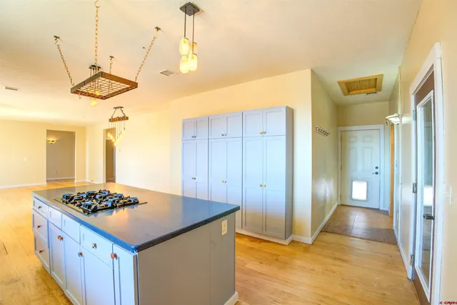 a bathroom with a granite countertop toilet and a sink