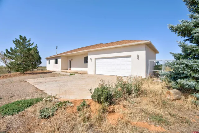a view of a house with yard and a garden
