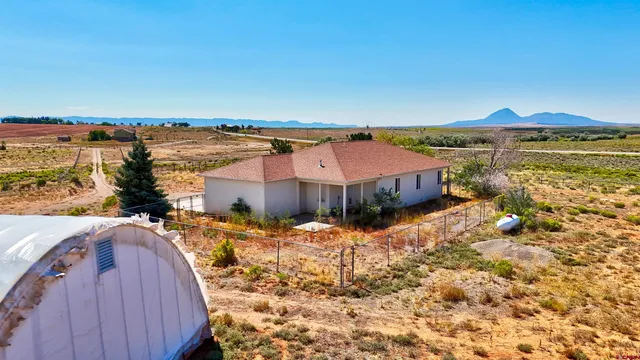 a view of a house with a yard and ocean view