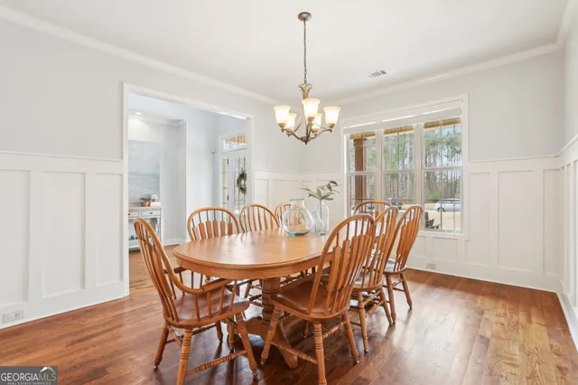 a view of a kitchen with wooden floor and staircase