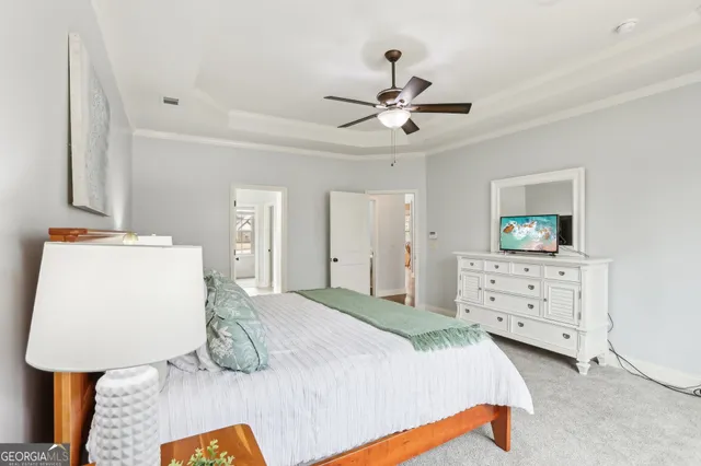 a bedroom with a large bed and a window