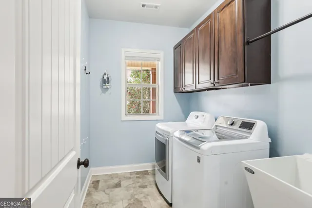 a en suite bathroom with a granite countertop sink and a mirror