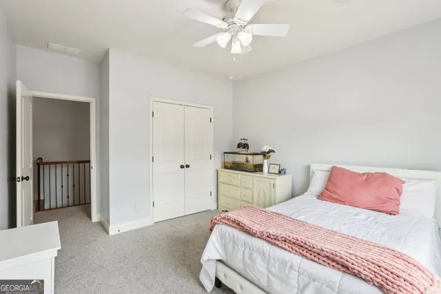 a view of a kitchen with kitchen island a sink a counter top space cabinets and stainless steel appliances