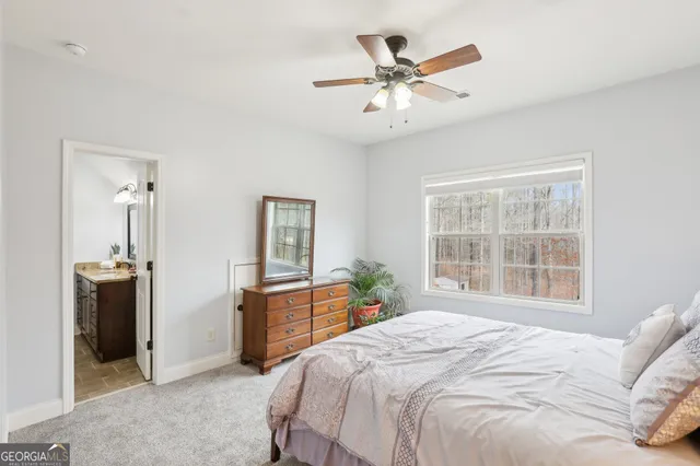 a spacious bedroom with a bed and a cabinets