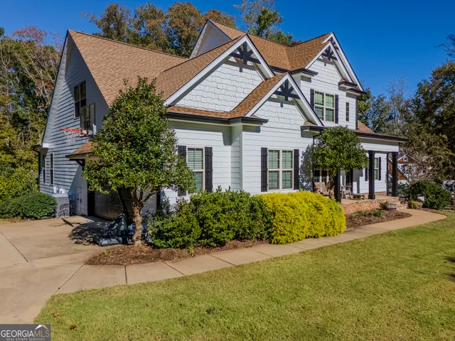 a dining room with furniture a chandelier and wooden floor