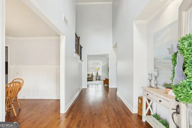 a view of a dining room with furniture wooden floor and chandelier
