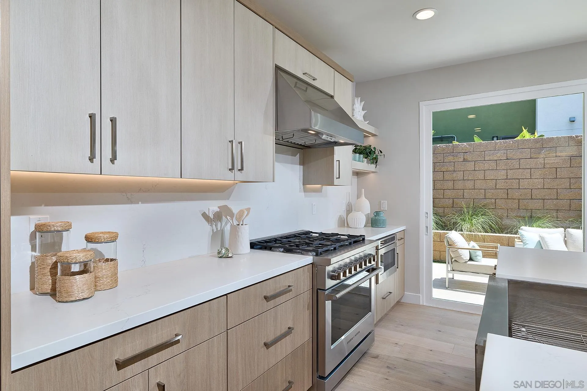 555 North Vulcan Avenue Encinitas, CA 92024 - Photo 9 of 32 a kitchen with stainless steel appliances granite countertop a sink and a stove