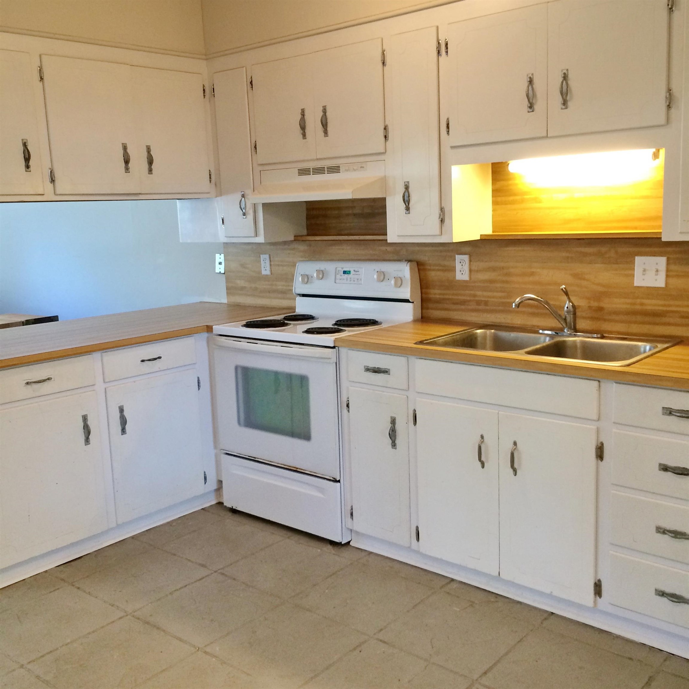 213 A Street St. Augustine, FL 32080 - Photo 13 of 29 a kitchen with white cabinets and white appliances