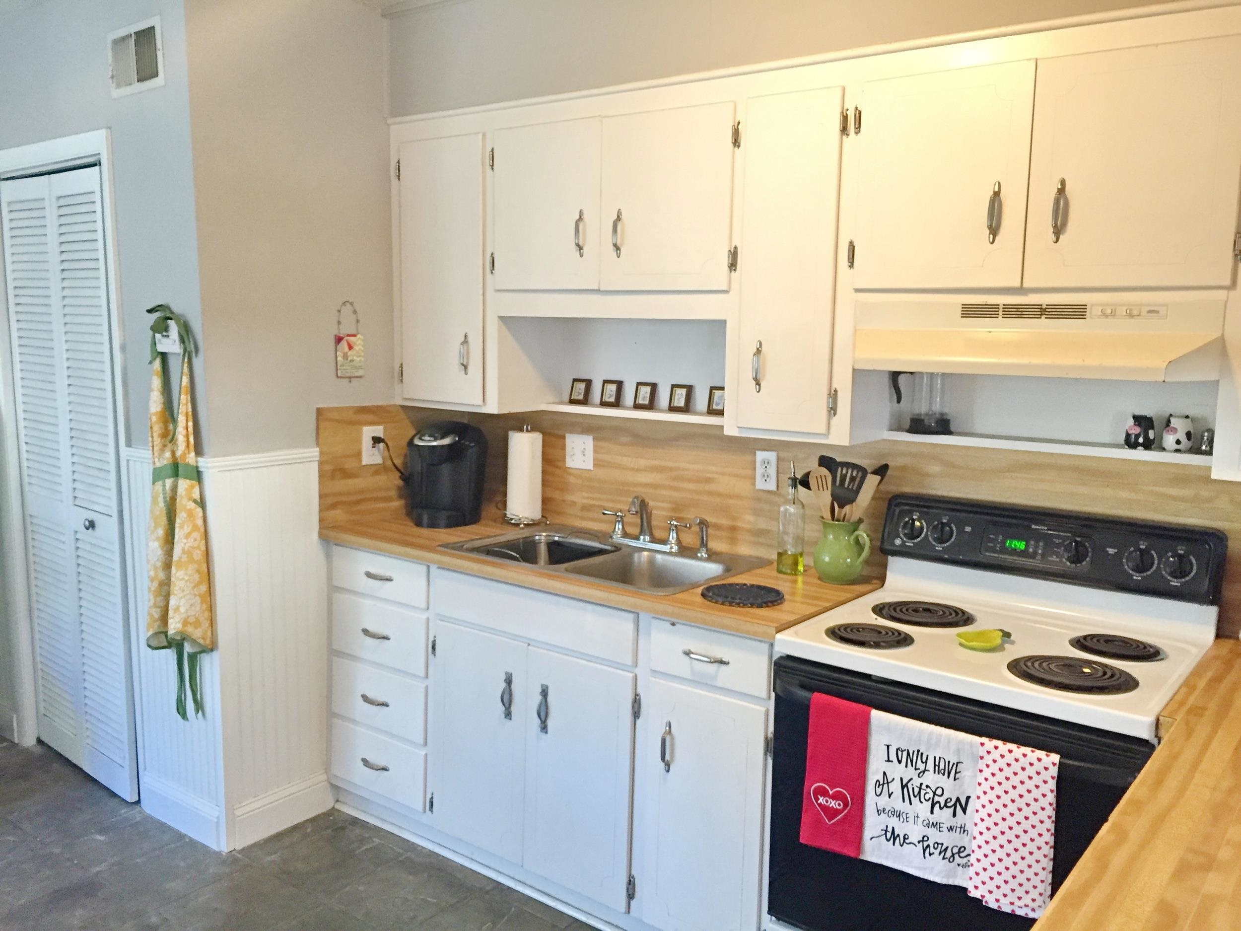 213 A Street St. Augustine, FL 32080 - Photo 16 of 29 a kitchen with a stove a sink and a microwave