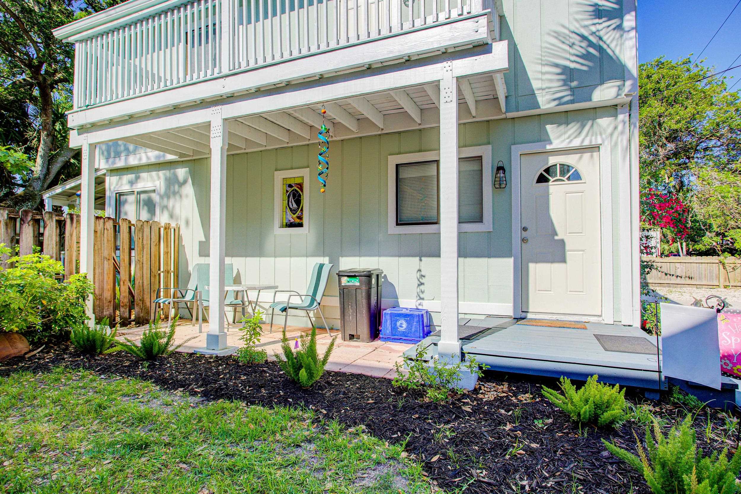 213 A Street St. Augustine, FL 32080 - Photo 4 of 29 a view of small house with potted plants and a table and chairs