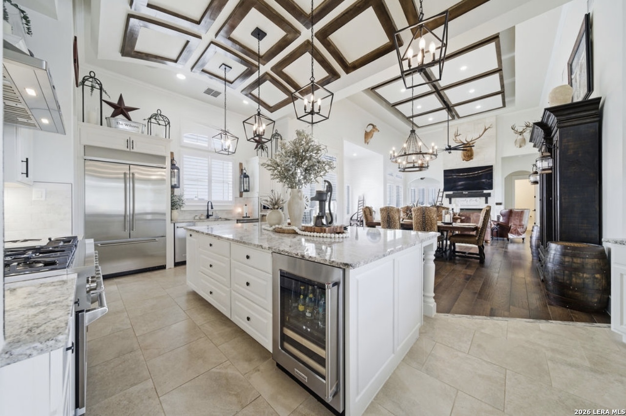 5920 Verden Ridge New Braunfels, TX 78132 - Photo 11 of 61 a kitchen with stainless steel appliances kitchen island granite countertop a large stove a refrigerator and a chandelier