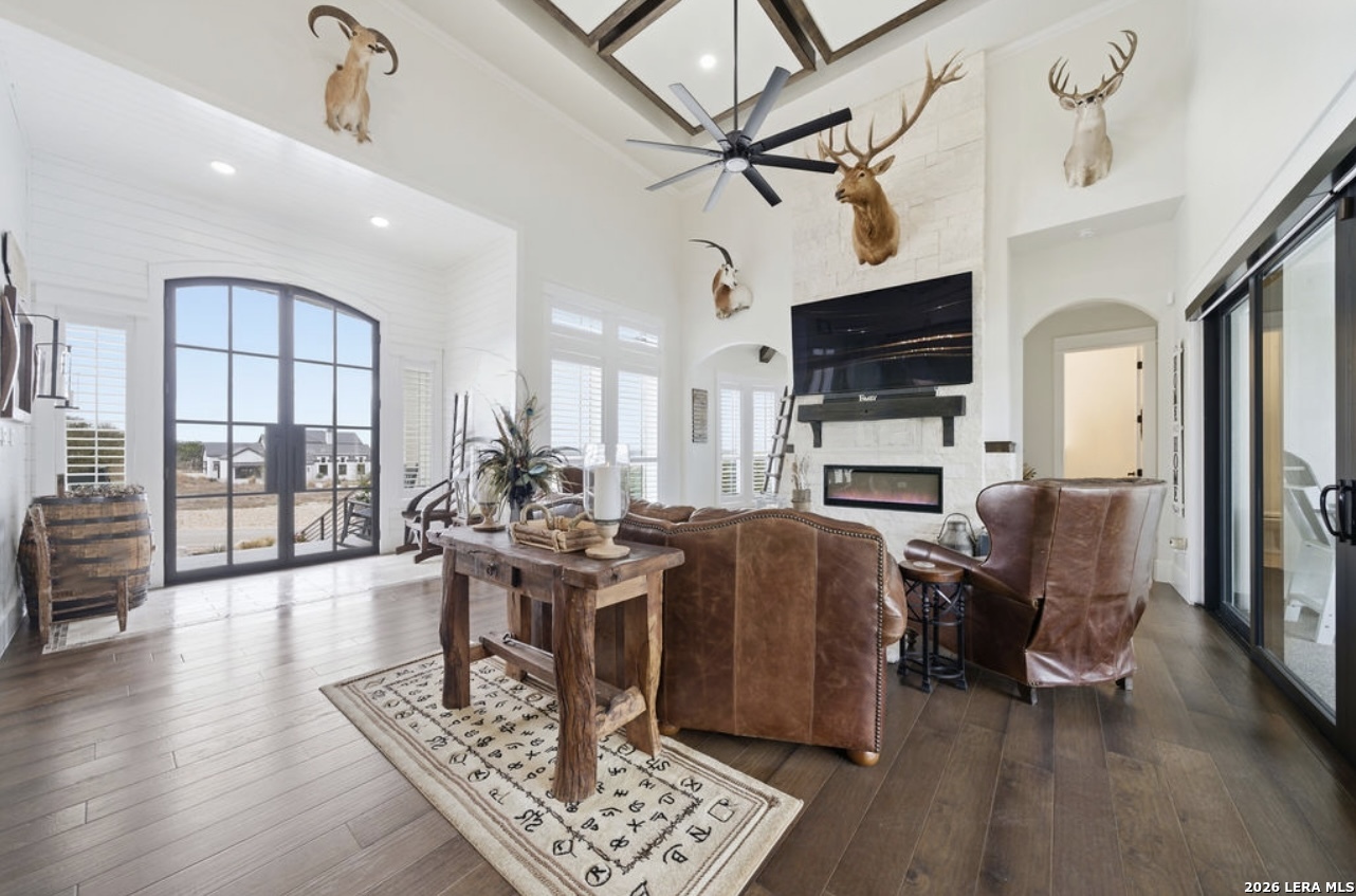 5920 Verden Ridge New Braunfels, TX 78132 - Photo 18 of 61 a living room with furniture a flat screen tv and a fireplace