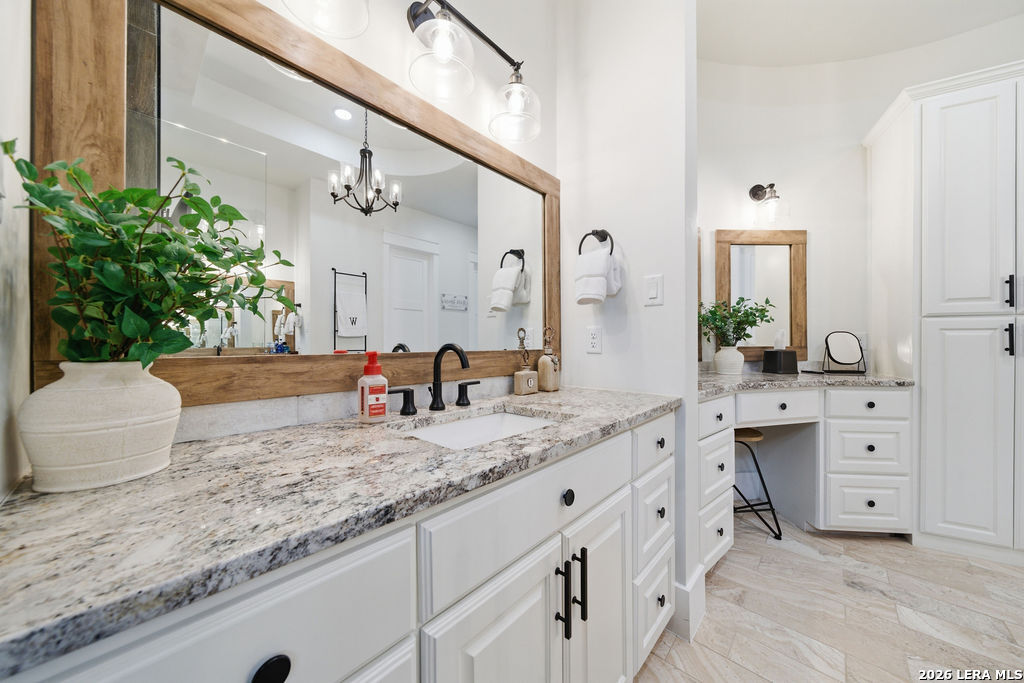 5920 Verden Ridge New Braunfels, TX 78132 - Photo 28 of 61 a bathroom with a granite countertop sink and a mirror