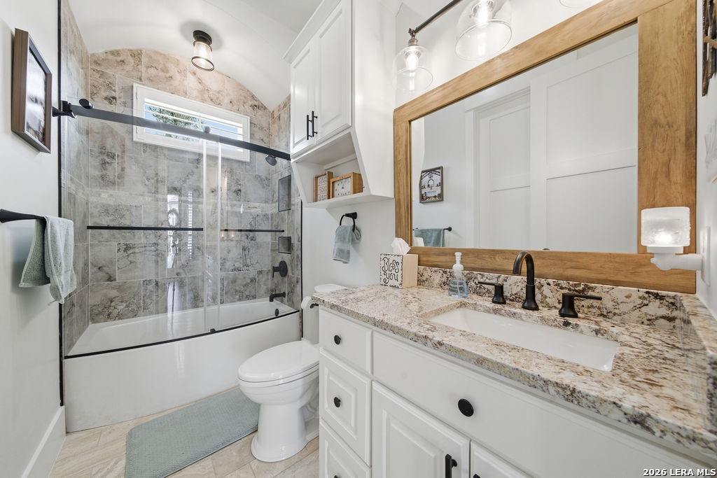 5920 Verden Ridge New Braunfels, TX 78132 - Photo 35 of 61 a bathroom with a granite countertop sink toilet a mirror and shower