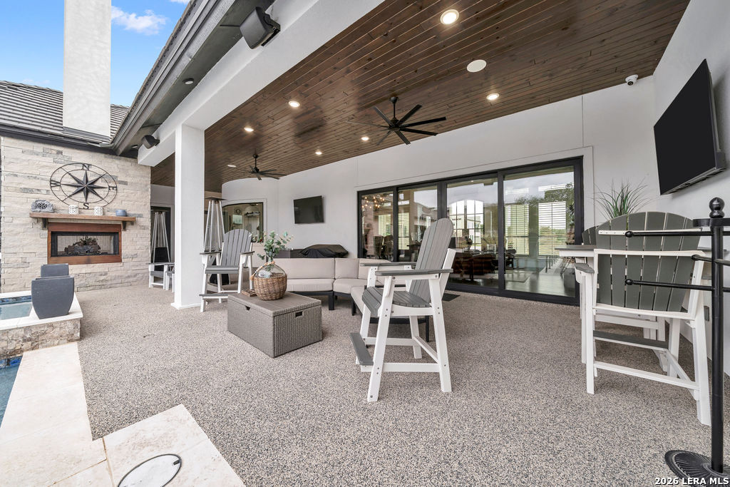 5920 Verden Ridge New Braunfels, TX 78132 - Photo 44 of 61 a living room with furniture a fireplace and a flat screen tv