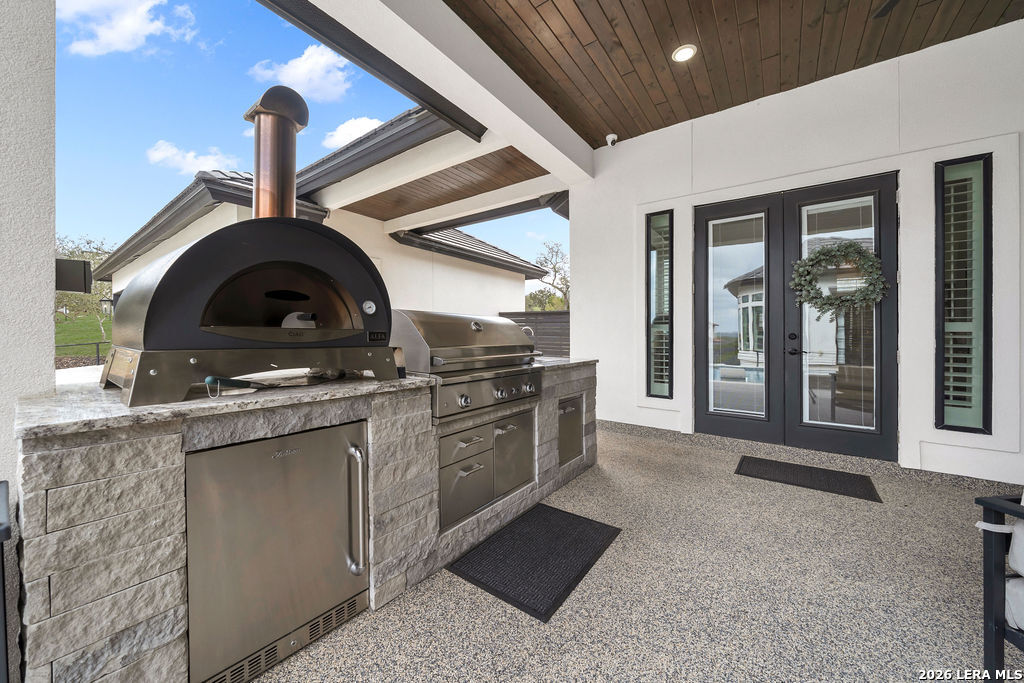 5920 Verden Ridge New Braunfels, TX 78132 - Photo 48 of 61 a kitchen with stainless steel appliances granite countertop a stove and a sink