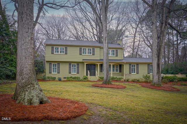 6801 Oak Ridge Drive Raleigh, NC 27612 - Photo 2 of 38 a front view of a house with garden