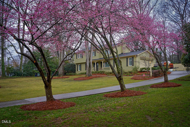 6801 Oak Ridge Drive Raleigh, NC 27612 - Photo 3 of 38 a front view of a house with garden and trees