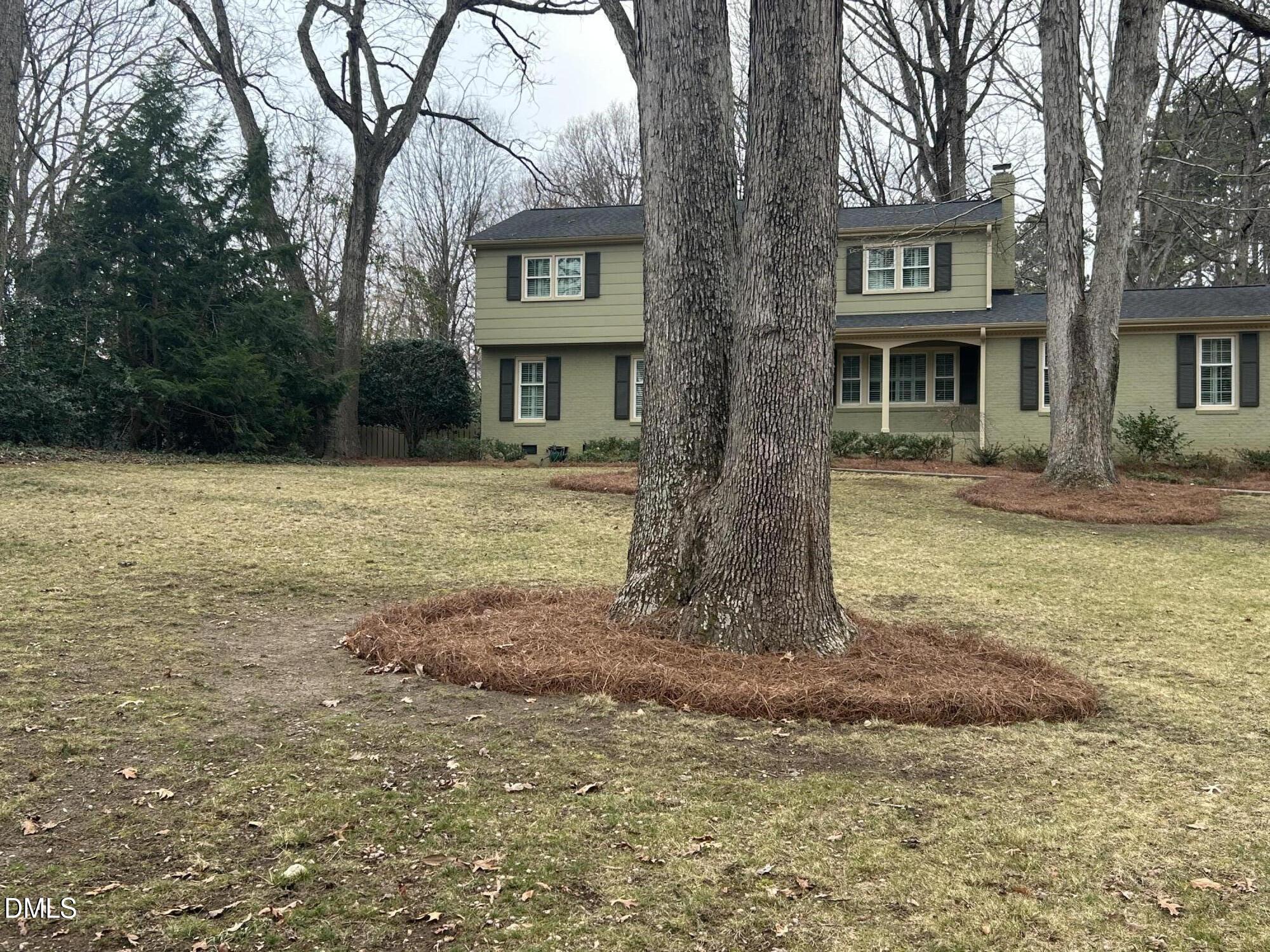 6801 Oak Ridge Drive Raleigh, NC 27612 - Photo 4 of 38 a front view of a house with garden