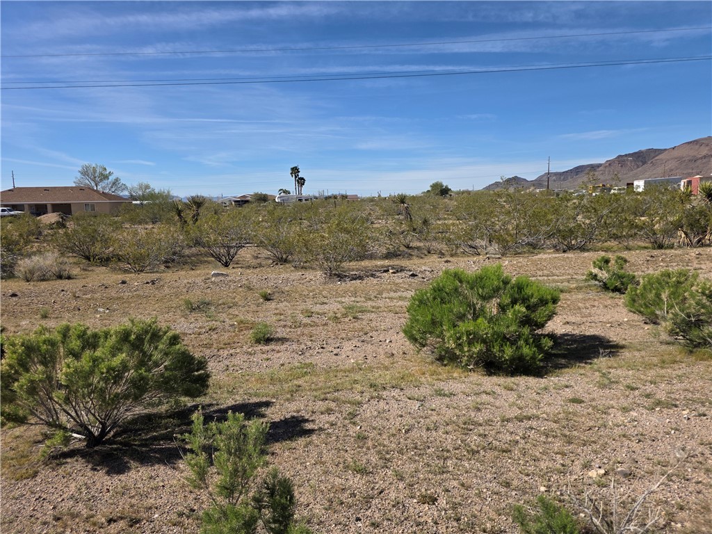 2904 Walnut Creek Road, Unit 2 LOT 5 Golden Valley, AZ 86413 - Photo 2 of 10 Expansive desert landscape with scattered green brush and distant mountain views