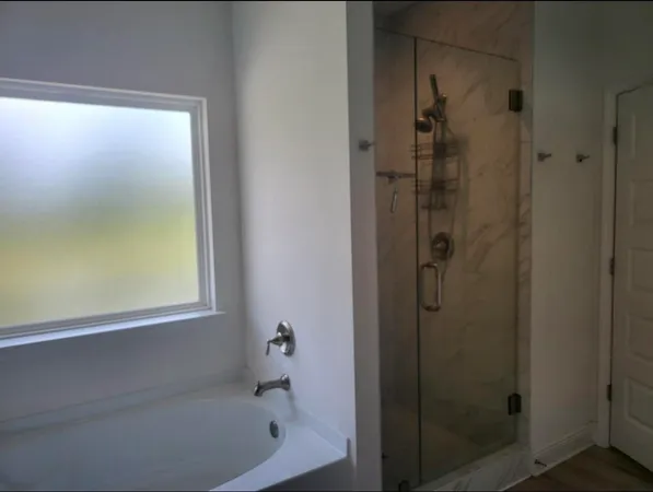 a bathroom with a bathtub and shower