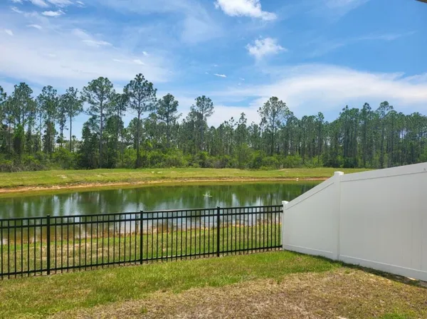 a view of a swimming pool and a yard
