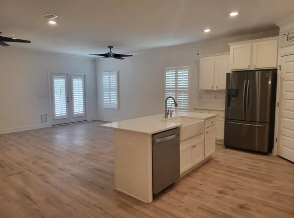 a kitchen with stainless steel appliances a refrigerator sink and cabinets