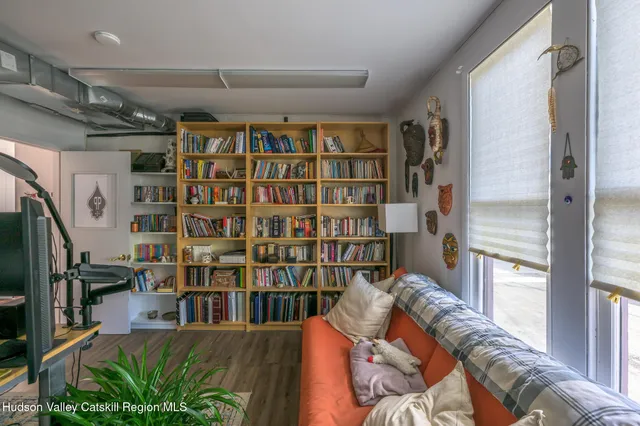 a room with furniture and a bookshelf