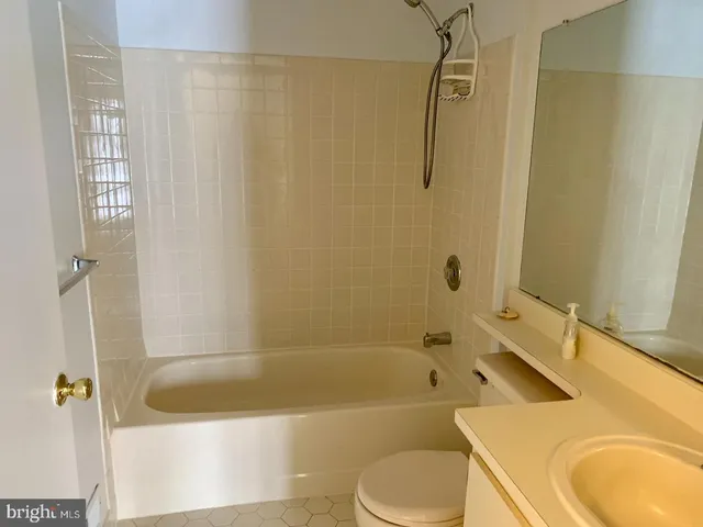 a bathroom with a sink a bath tub a toilet and a shower