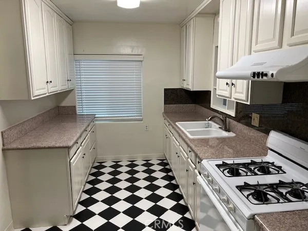 a kitchen with a stove and a sink