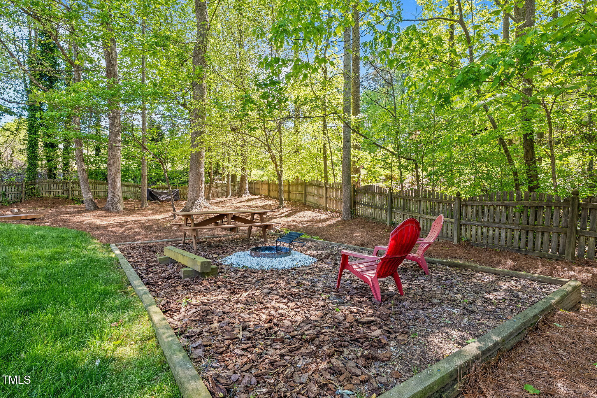 4513 Touchstone Forest Road Raleigh, NC 27612 - Photo 47 of 79 a backyard of a house with table and chairs