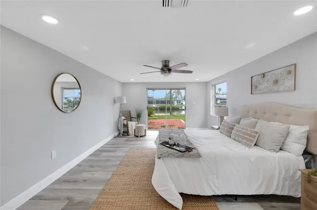 a bed room with a bed mirror and a window
