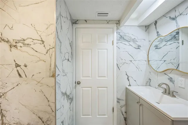 a bathroom with a sink and shower