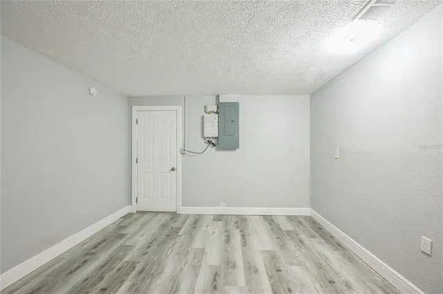 a view of room with wooden floor and white walls