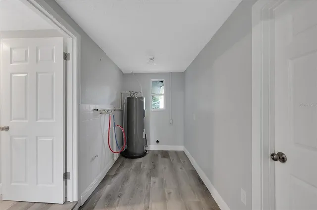 a view of a hallway with wooden floor