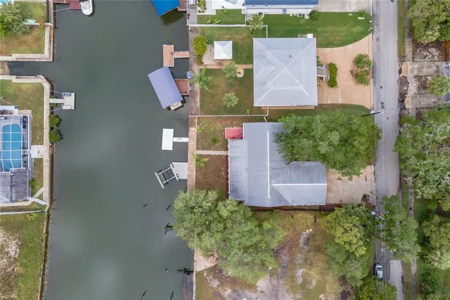 an aerial view of residential house with outdoor space and swimming pool