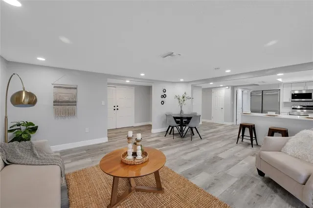 a living room with furniture and a wooden floor
