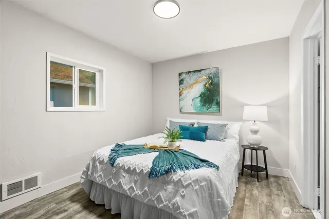 a bedroom with a bed and a window