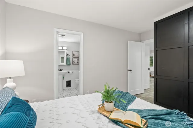 a bed room with a bed and a potted plant