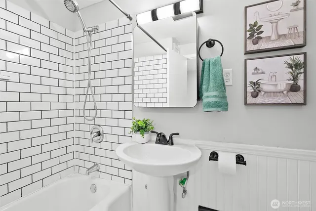 a bathroom with a sink a bathtub and shower