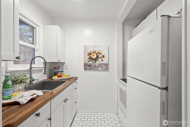 a kitchen with a refrigerator and a sink