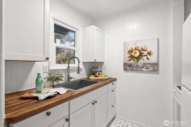 a kitchen with stainless steel appliances granite countertop a sink a stove and a window