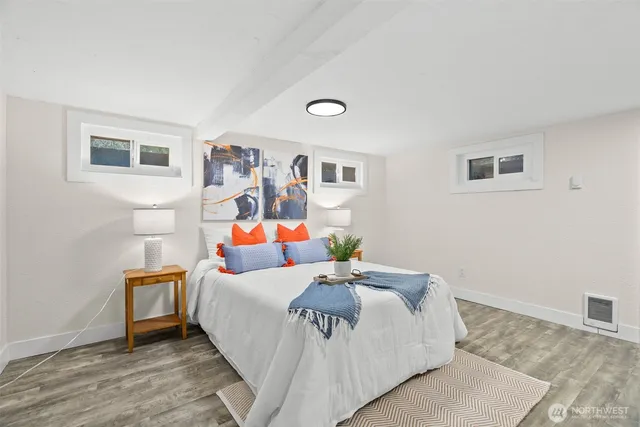 a bedroom with a bed and wooden floor