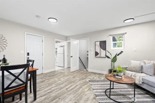 a living room with furniture a wooden floor and a window